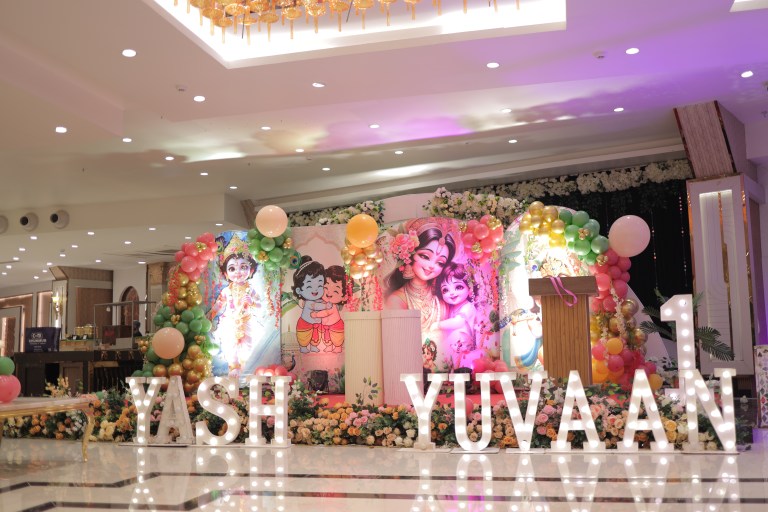 Krishna theme birthday stage with name letters and balloons in Noida