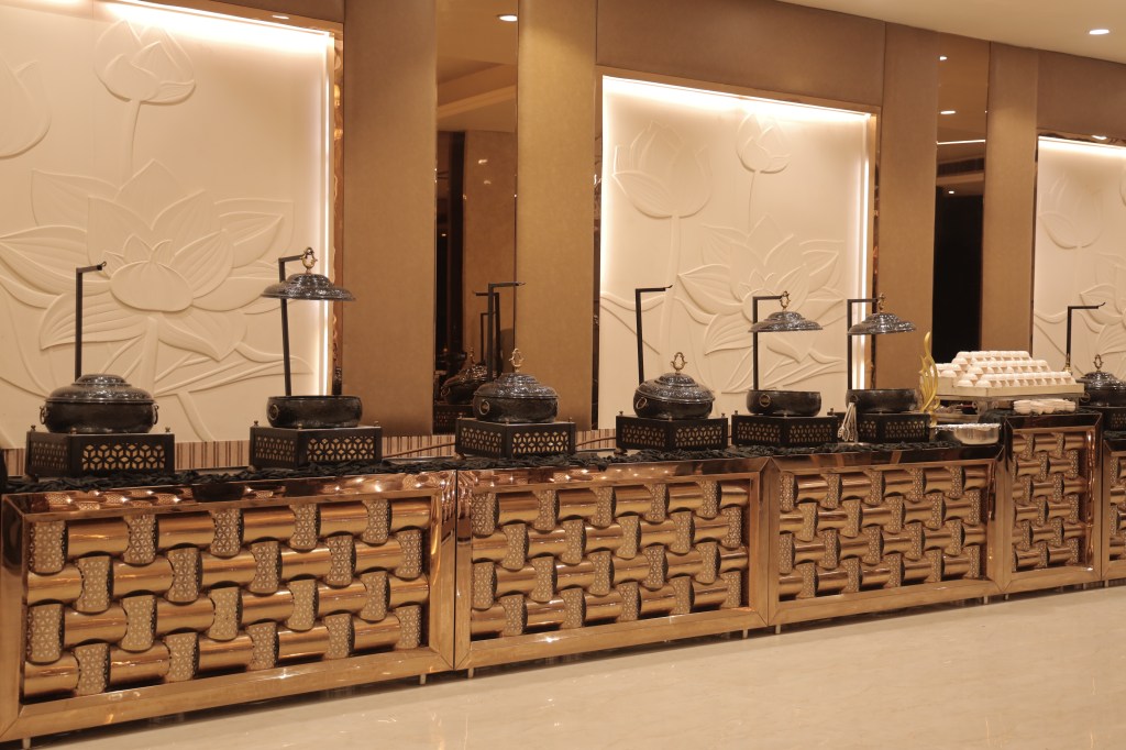 Buffet counters set up at a catered event in Noida by Mithila Events
