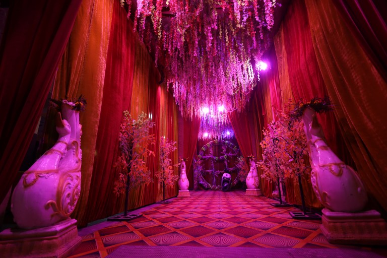 Banquet hall lit in pink for a sangeet function in Noida