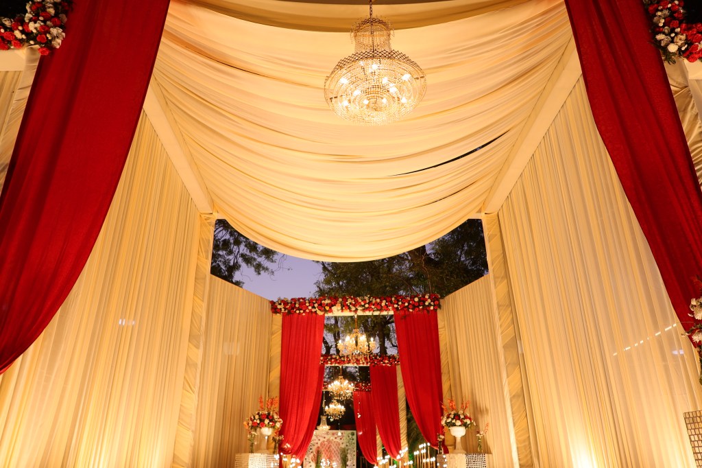 Draped ceiling with chandelier above a wedding stage in Noida