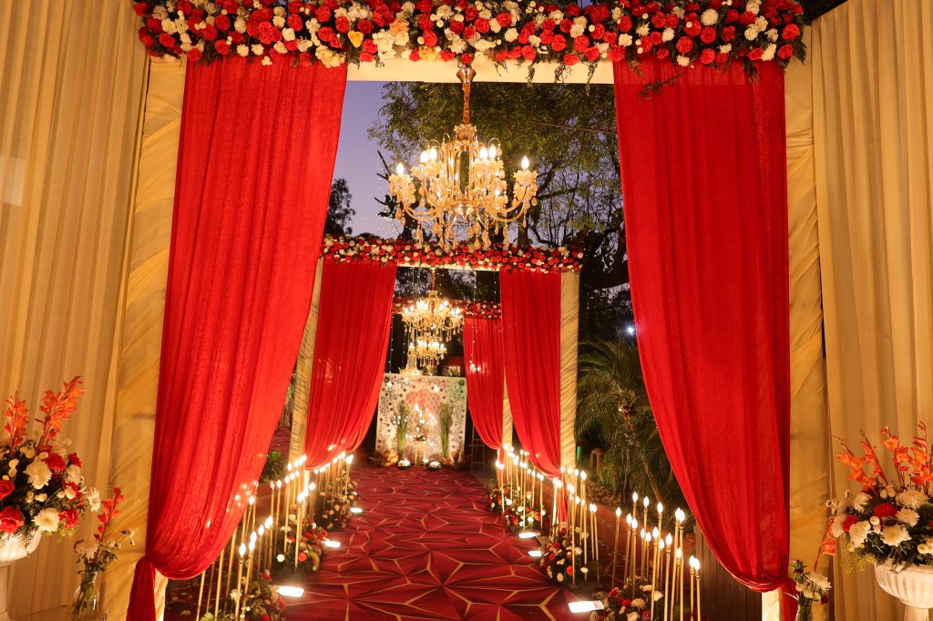 Draped entrance and lit walkway at a wedding venue in Noida