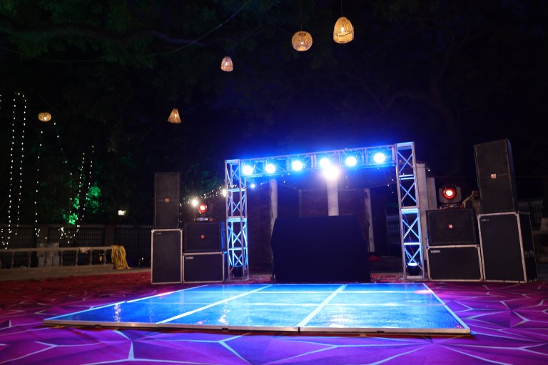 Truss lighting and DJ stage setup at an outdoor event in Noida