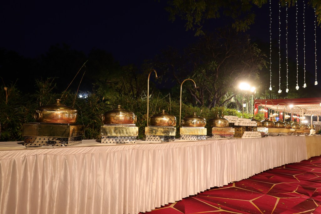 Farmhouse lawn set up with tents and lighting for a wedding near Noida