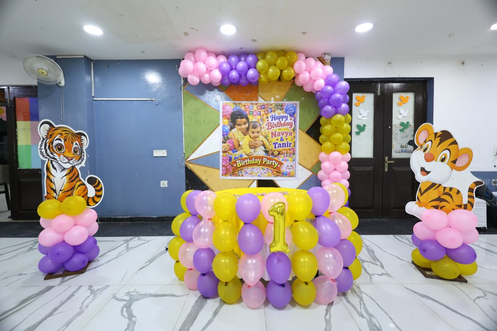 Pink, purple and gold balloon stage for a birthday party by Mithila Events