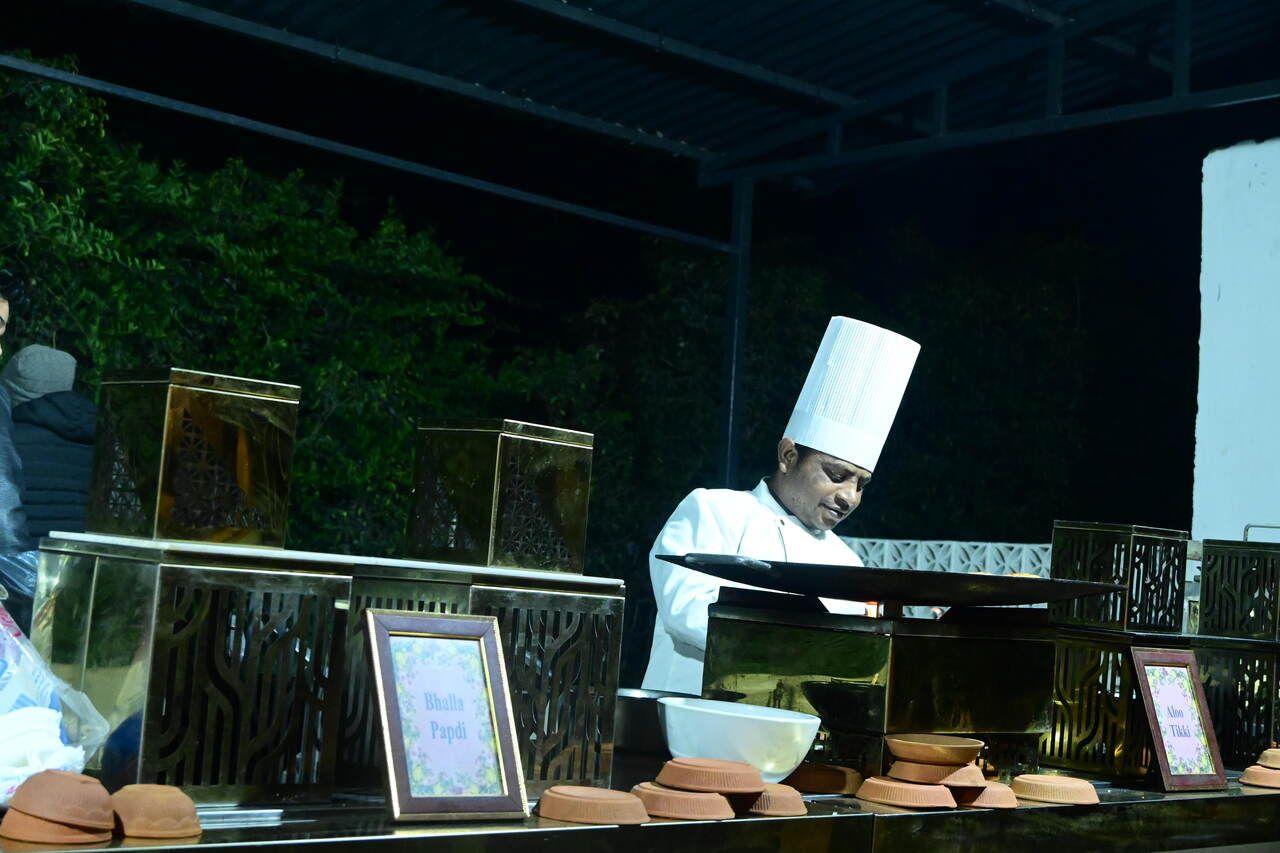 Chef at a live tawa counter at a party catered by Mithila Events in Noida