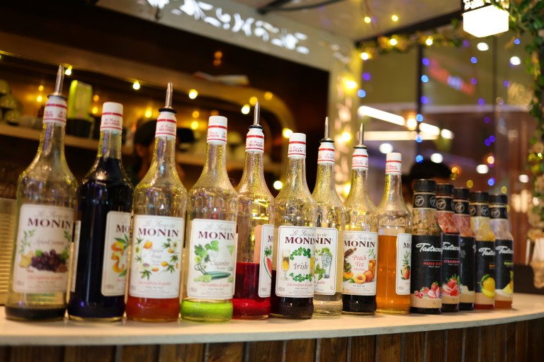 Live mocktail counter with syrups and glasses at a party in Noida
