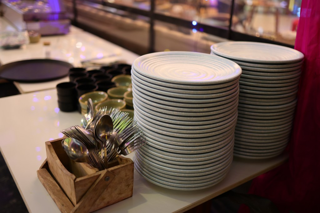Stacked crockery ready at a buffet counter, Mithila Events Noida